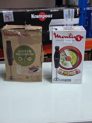 two boxes of food sitting on a table next to each other