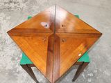 a wooden table with two green chairs on it
