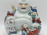 a statue of a man sitting on a pile of toys