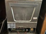 a silver dishwasher sitting inside of a wooden cabinet
