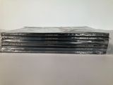 a stack of four cds sitting on top of each other