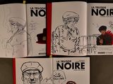 four books with drawings of a man in a hat and a man in a hat