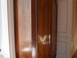 a large wooden cabinet in a room with a radiator