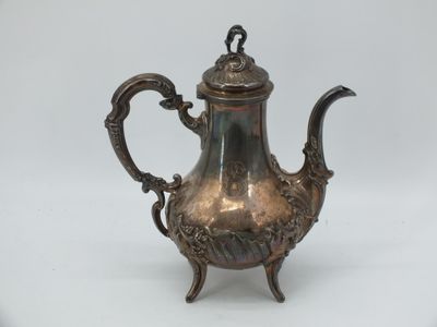 an antique silver tea pot with a handle on a stand