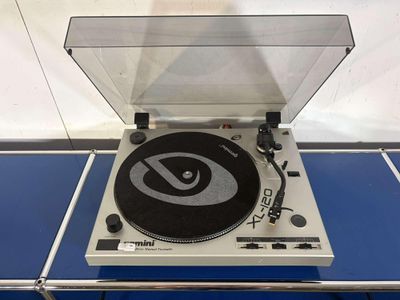 a record player sitting on top of a blue table