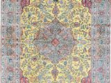 a yellow and blue rug with a medallion design on it
