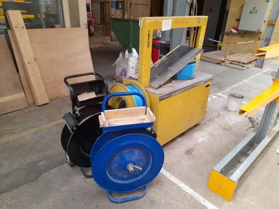 a blue and yellow machine that is sitting on the ground