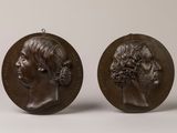 a pair of bronze medallions depicting a man and a woman