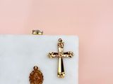 a white marble box with a gold cross and a wax seal on it