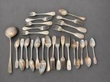 a lot of spoons and forks laid out on the table