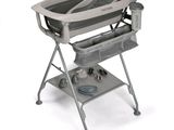 a baby ' s changing table with a baby in it