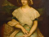 portrait d'une jeune fille vêtue d'une robe verte et d'un bonnet