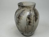 a vase that is sitting on a white surface