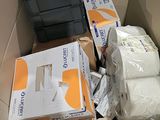 a box full of toilet paper and toilet paper on the floor