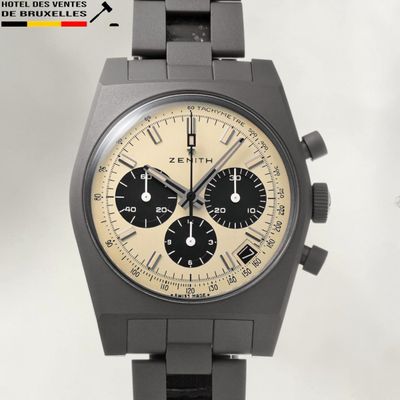 an image of a black watch with a tan dial and black bracelet