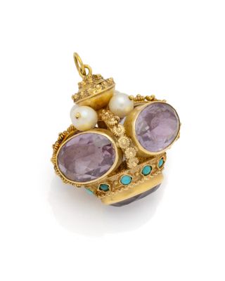 a close up of a gold and amethorate pendant with pearls