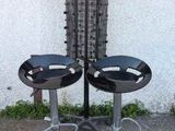 two stools that are sitting in front of a building