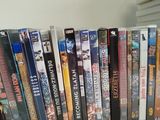 a lot of dvd ' s on a shelf next to each other