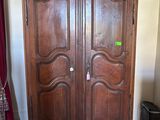 an image of a large wooden armoire in a living room