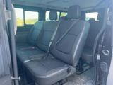 the back seats of a van with black leather seats in a parking lot