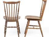 pair of wooden chairs against a white background