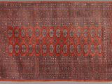 a red and black rug with a medallion design on it