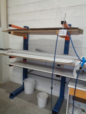 a workbench in the middle of a room with two buckets on it