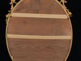 an image of a round mirror with a wooden frame on a black background