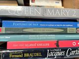 many books stacked on top of each other in a box