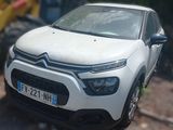 a white car that is parked on the side of the road