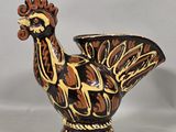 a ceramic bird that is sitting on a table