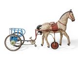 a toy horse pulling a cart with a man in it