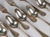 a lot of silver spoons and forks on the table