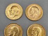 four gold coins with a portrait of a man and a woman on them