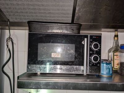un micro-ondes posé sur une étagère dans une cuisine