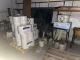 several rolls of toilet paper are stacked on pallets in a room