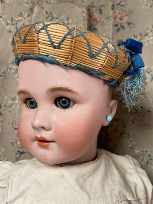 a small doll with a crown on it ' s head