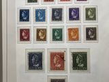 a framed picture of a collection of stamps on display in a museum