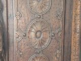 a wooden cabinet with carvings on it in a room