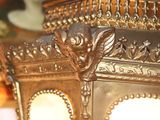 a gold colored lamp that has a dragon on it