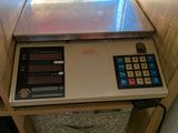 une calculatrice posée sur une étagère devant une fenêtre