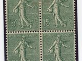 four stamps of a woman with a basket of flowers on them