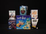 a lot of board games on display on a black table