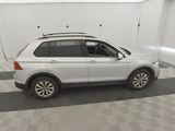the white volkswagen suv is parked in a clean garage