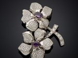 a close up of a brooch with diamonds and a cross