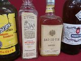 several bottles of alcohol are lined up on a red surface