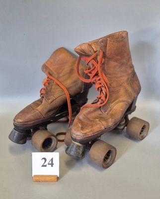 a pair of old roller skates with wheels and laces