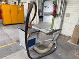 a machine that has a hose attached to it ' s side