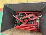a box full of red pipe wrenes and chains
