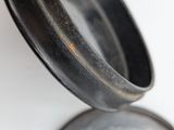 a close up of a metal object on a white surface